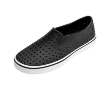 Angled view of a Native Shoes Miles | Jiffy Black / Shell White Footwear in Jiffy Black / Shell White