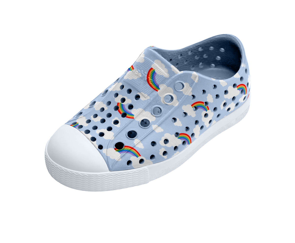 Angled view of a Native Shoes Kids Jefferson Print Kids | Skyway Blue / Shell White / Cloud Rainbow Footwear in Skyway Blue / Shell White / Cloud Rainbow