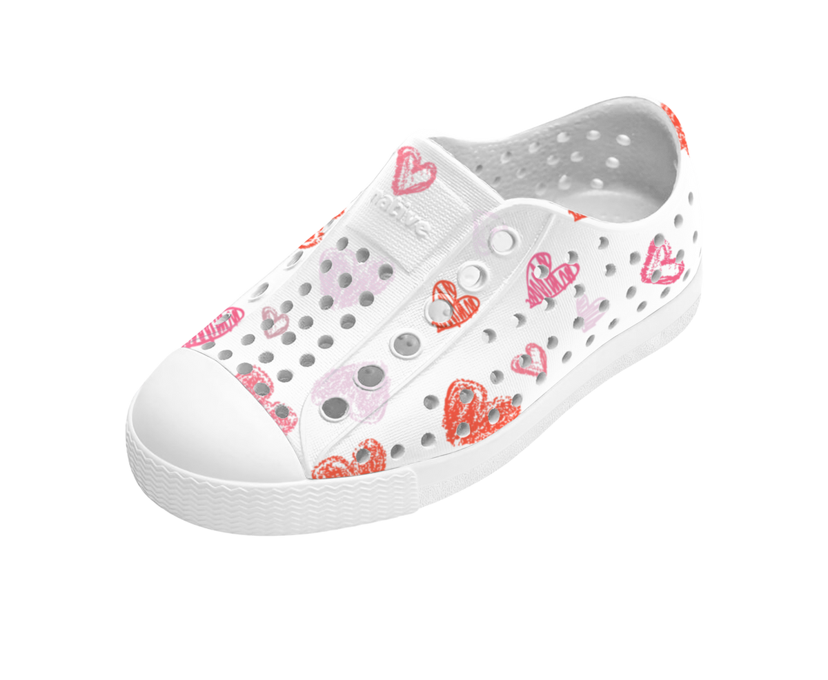 Angled view of a Native Shoes Kids Jefferson Print Kids | Shell White / Shell White / Heart Graffiti Footwear in Shell White / Shell White / Heart Graffiti