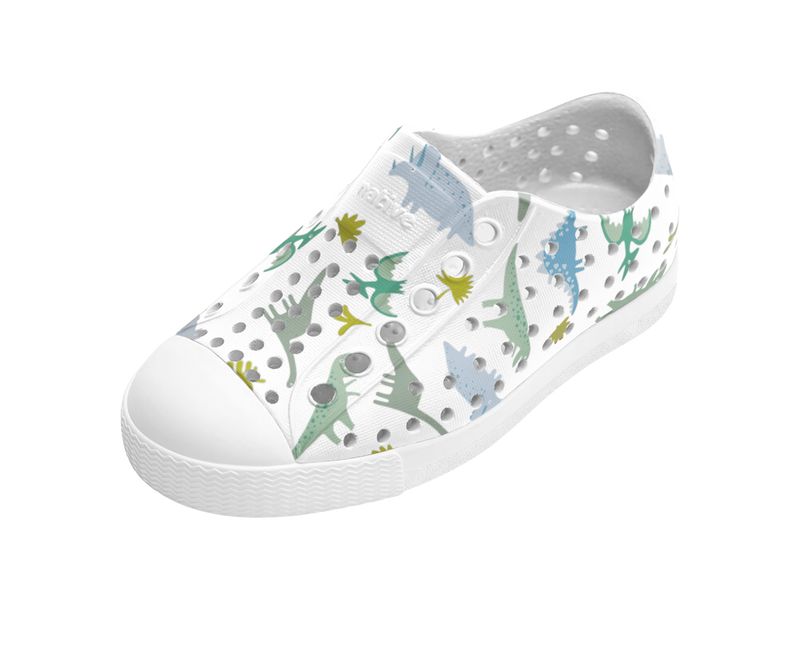 Angled view of a Native Shoes Kids Jefferson Print Kids | Shell White / Shell White / Flux Alpine Dino Footwear in Shell White / Shell White / Flux Alpine Dino