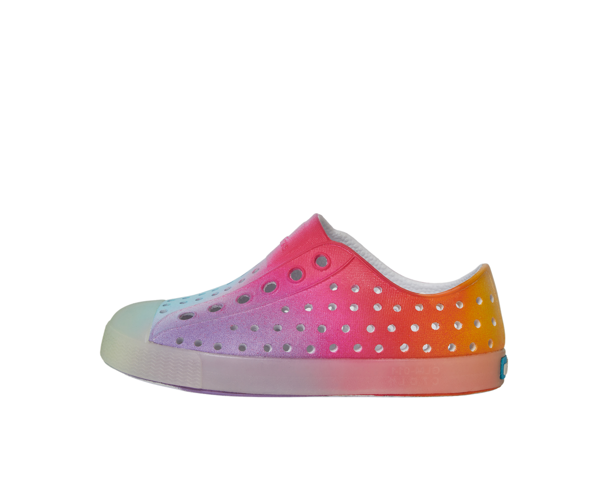 Side view of a Native Shoes Kids Jefferson Print Kids Footwear in Shell White / Transparent / Rainbow Spray