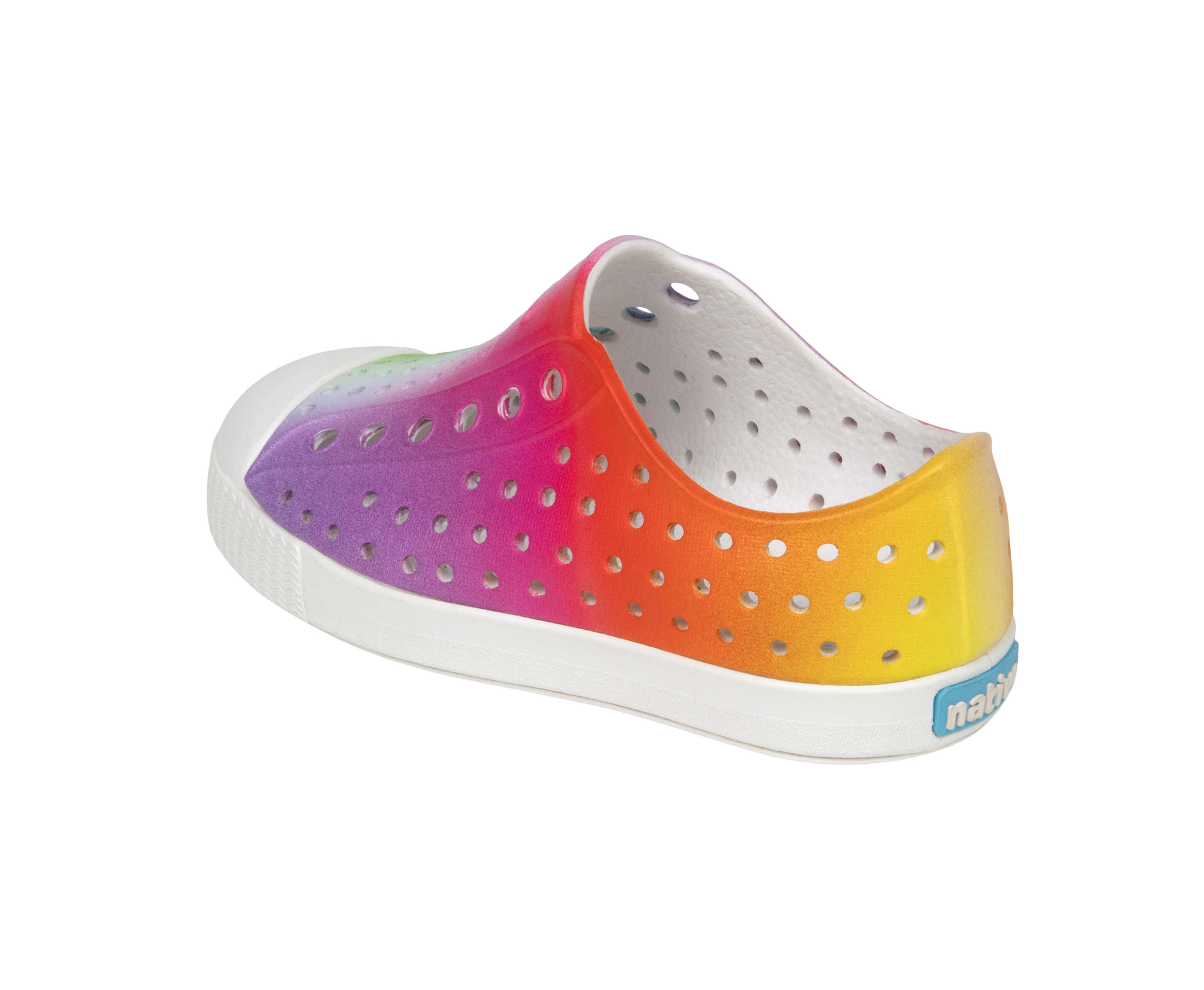 Angled view of a Native Shoes Kids Jefferson Print Kids | Shell White / Transparent / Rainbow Spray Footwear in Shell White / Transparent / Rainbow Spray