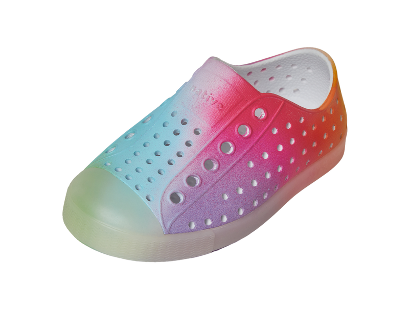 Angled view of a Native Shoes Kids Jefferson Print Kids | Shell White / Transparent / Rainbow Spray Footwear in Shell White / Transparent / Rainbow Spray