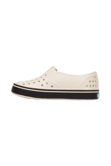 Angled view of a Native Shoes Kids Miles Kids | Bnwht/Jfyblk Footwear in Bnwht/Jfyblk