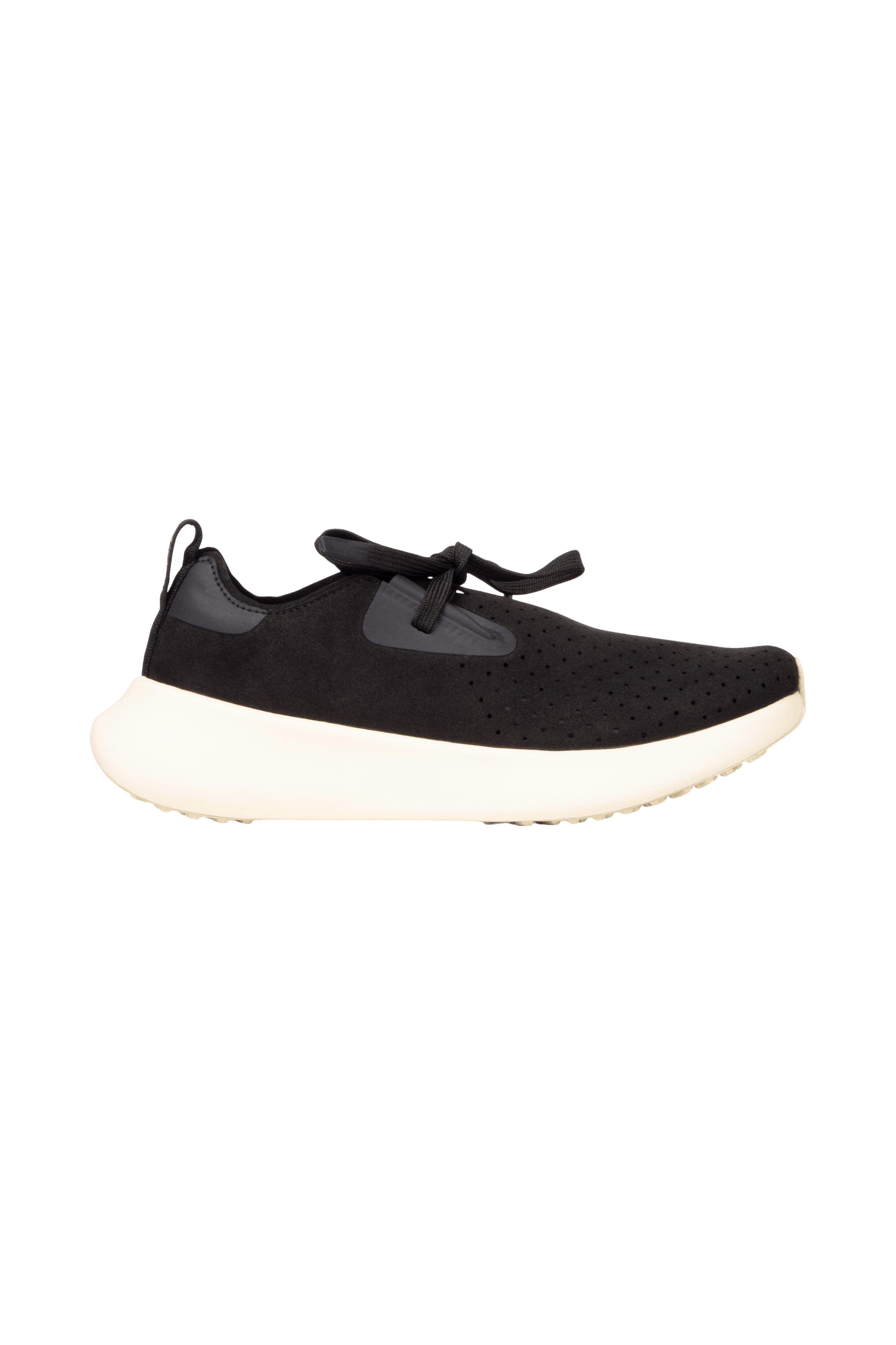 Side view of a Native Shoes Adults Apollo 10 Footwear in Jiffy Black / Tapioca Off White