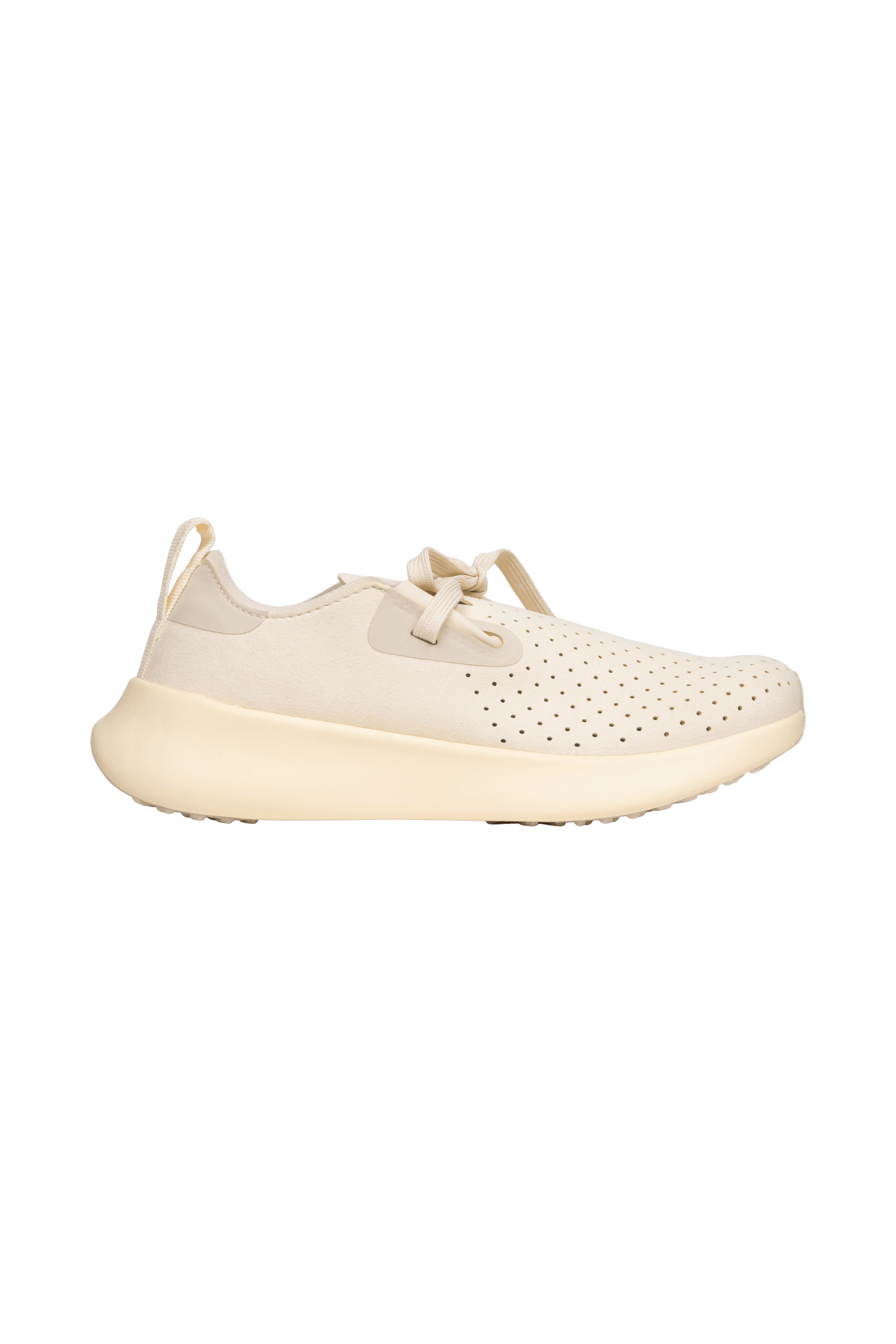 Side view of a Native Shoes Adults Apollo 10 Footwear in Bone White / Tapioca Off White