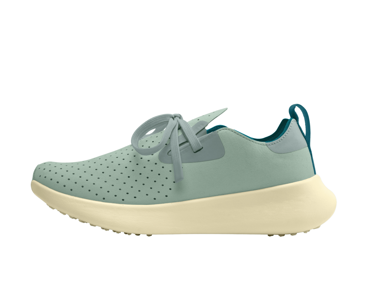 Side view of a Native Shoes Adults Apollo 10 Footwear in Relax Green / Tapioca Off White