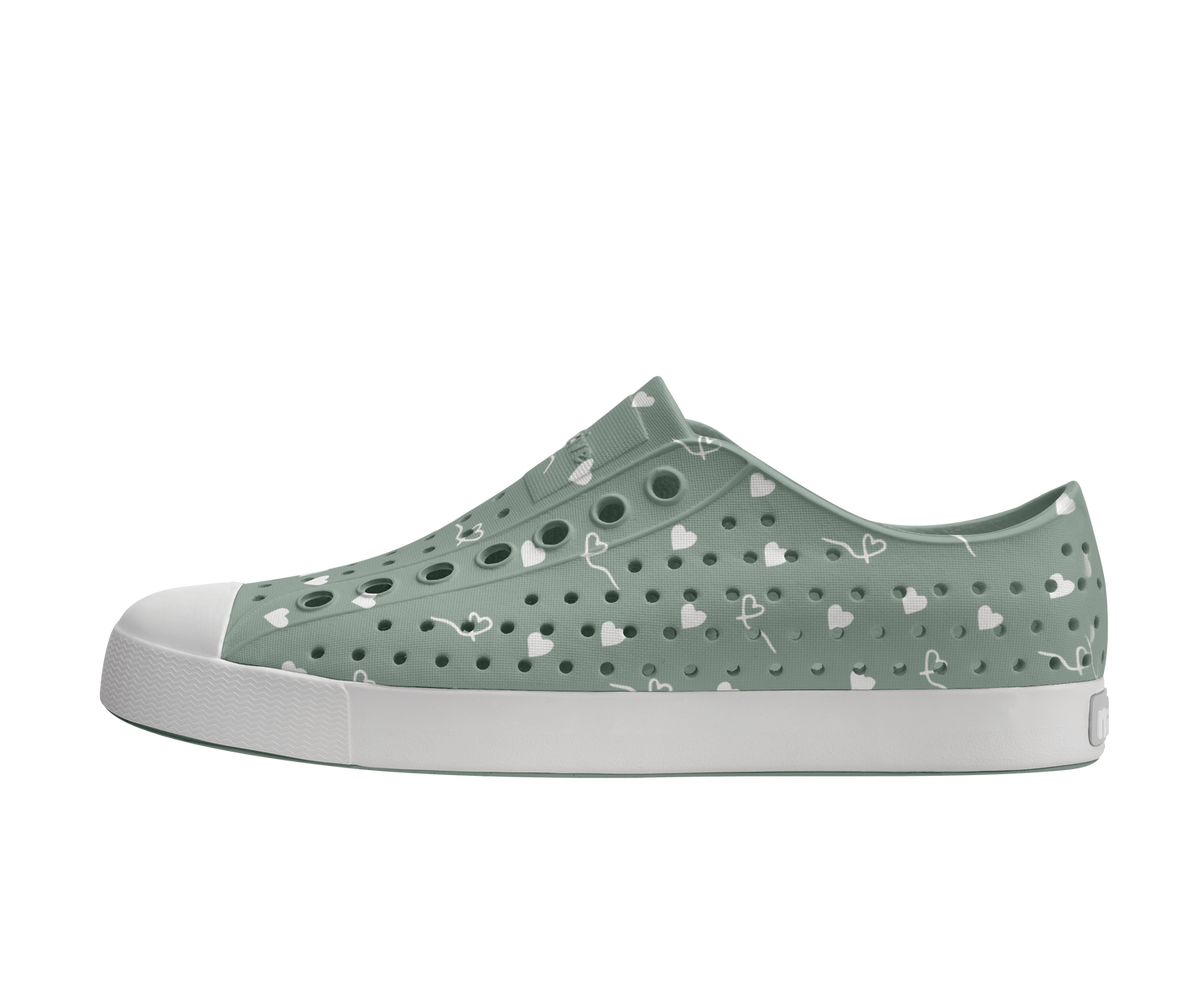 Side view of a Native Shoes Adults Jefferson Wanderfoam Print Footwear in Relax Green / Shell White / Freesia Star Badge