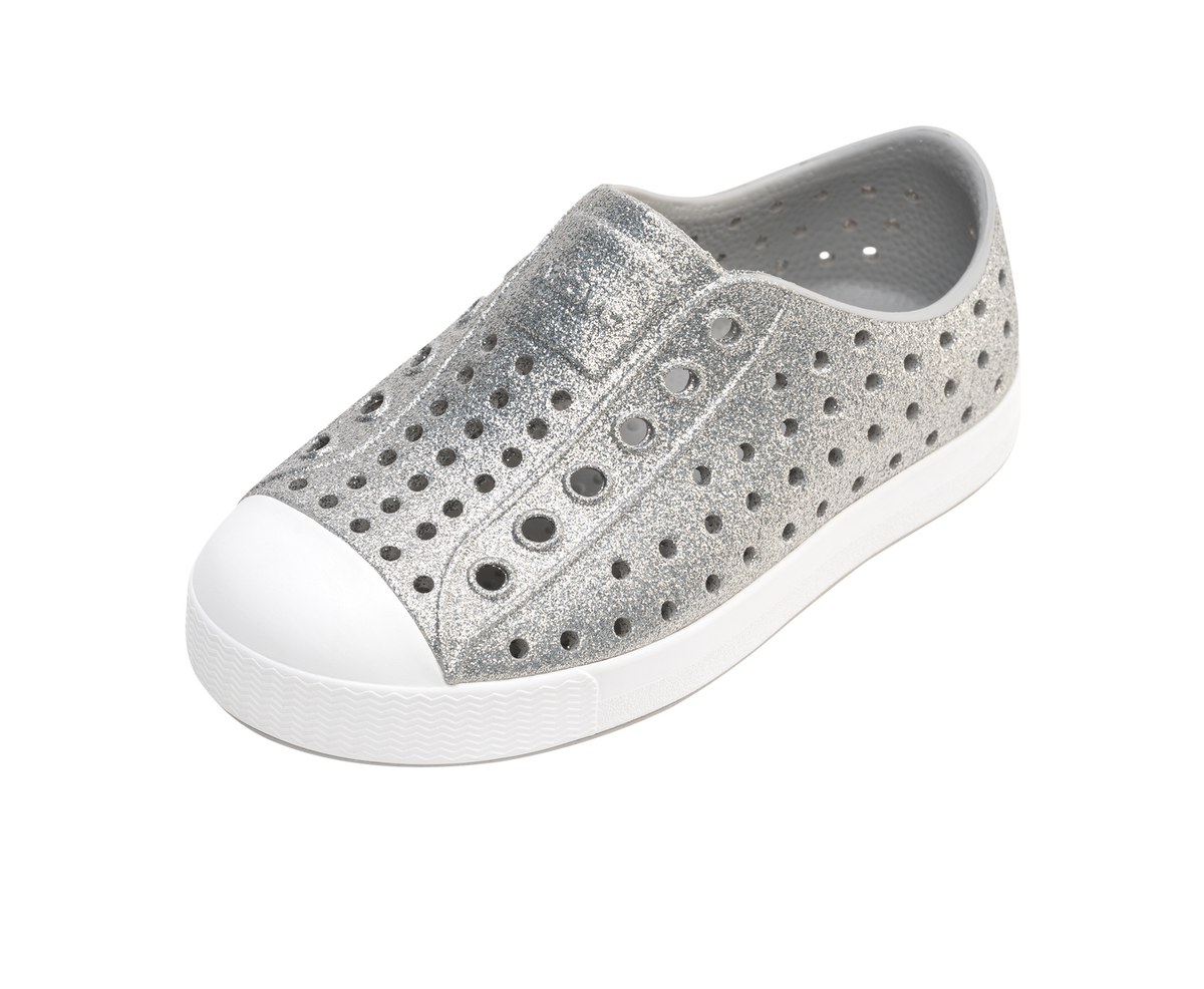 Angled view of a Native Shoes Kids Jefferson Bio-Bling Kids | Platinum Bling / Shell White Footwear in Platinum Bling / Shell White