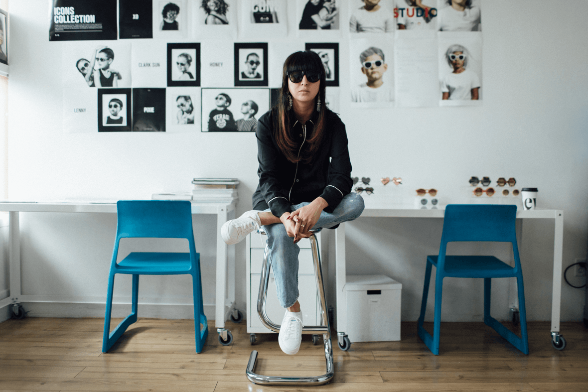 Shiva Shabani wears the Native Shoes Jefferson 2.0 on a stool in her studio for Sons and Daughters eyewear.