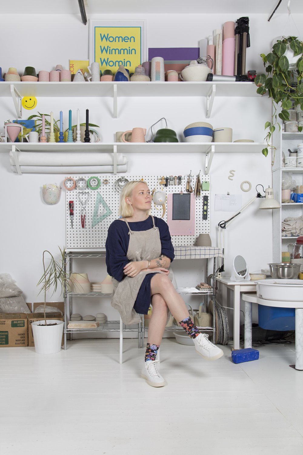 woman sitting on stool pondering