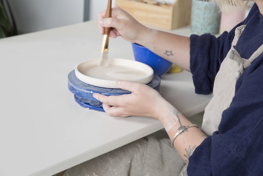 close-up view of woman making pottery