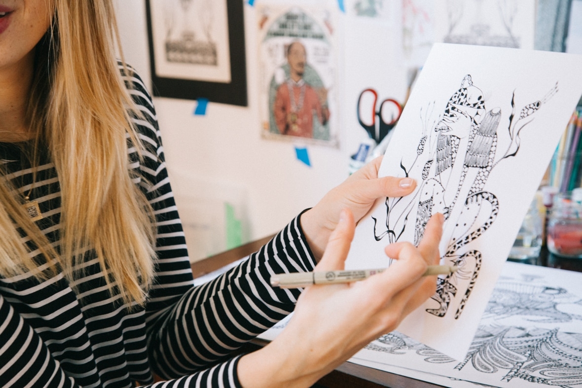 Ola Volo holding a sketch in her studio.