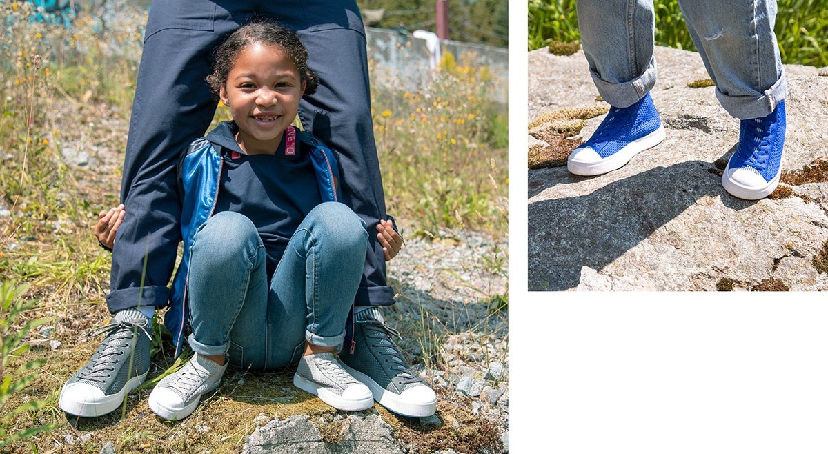 Girl is crouching and wearing slip on knit sneakers. Girl is wearing blue high top sneakers.